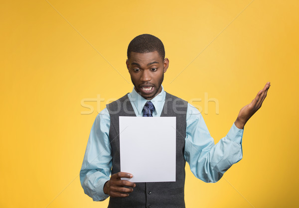 Man holding paper, statement, shocked with bad news Stock photo © ichiosea