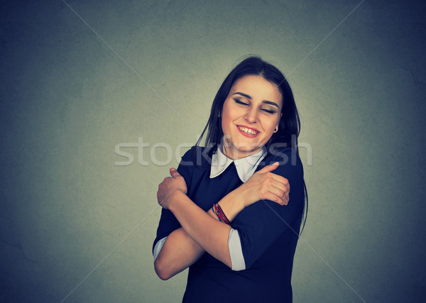 smiling woman holding hugging herself Stock photo © ichiosea