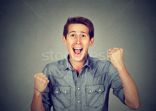 Happy successful man winning, fists pumped celebrating success Stock photo © ichiosea