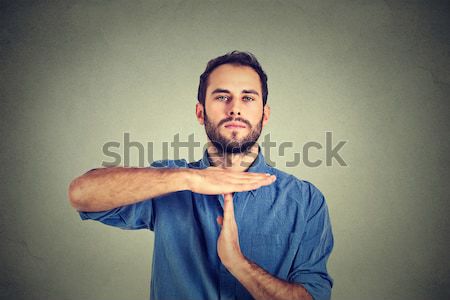 Young man giving showing time out hands gesture Stock photo © ichiosea