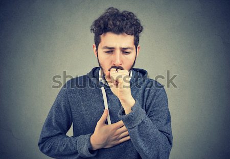disgusted man pinches nose with fingers hands looks with disgust something stinks  Stock photo © ichiosea