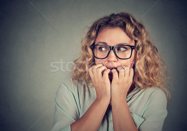 nervous stressed young woman biting fingernails looking anxiously  Stock photo © ichiosea