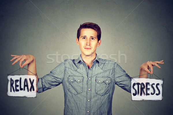 Stress entspannen junger Mann halten zwei Zeichen Stock foto © ichiosea