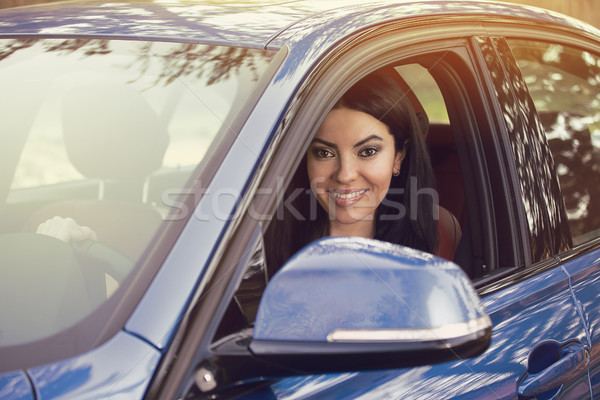 Happy smiling young woman sitting inside her new modern car  Stock photo © ichiosea