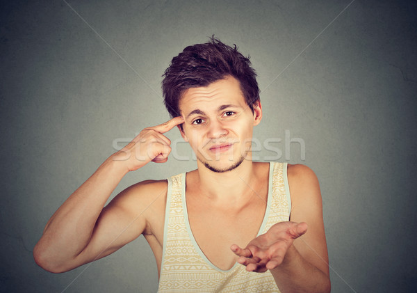 angry mad young man gesturing with finger are you crazy?  Stock photo © ichiosea