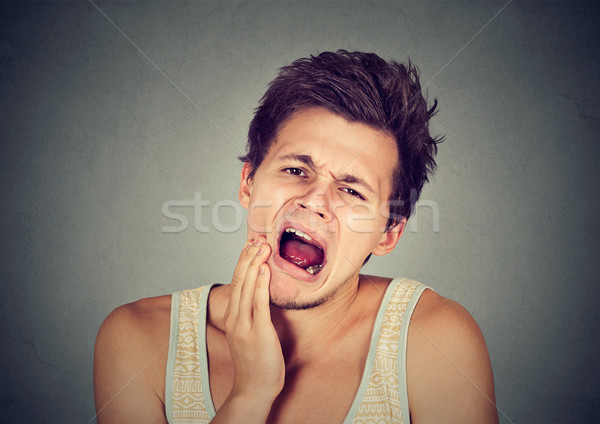 Om durere de dinti dinte durere tânăr sănătate Imagine de stoc © ichiosea