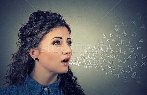 Woman talking with alphabet letters coming out of her mouth. Communication concept Stock photo © ichiosea