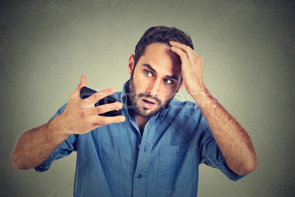 portrait, shocked man feeling head, surprised he is losing hair, receding hairline Stock photo © ichiosea