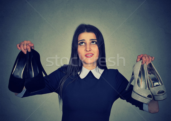 Perplexed woman keeps two stylish pumps can't choose one for her Stock photo © ichiosea