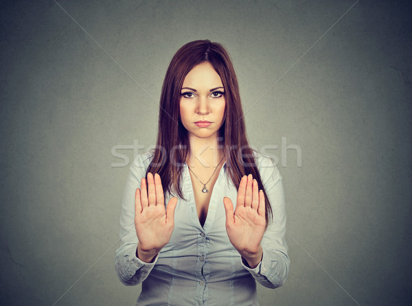 Angry displeased woman raising hands up to say no, stop  Stock photo © ichiosea