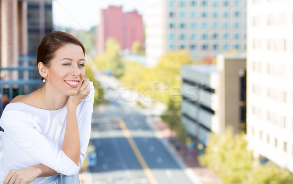Beautiful smiling young woman enjoying her day on a balcony of her apartment  Stock photo © ichiosea