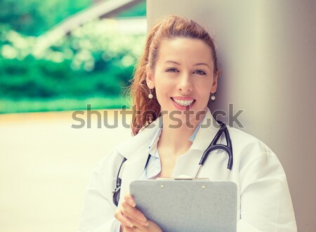 Smiling female doctor on phone Stock photo © ichiosea
