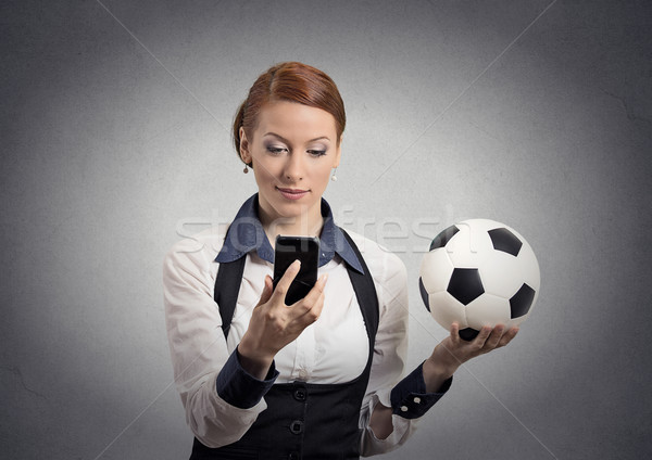 business woman looking on smartphone watching game holding football  Stock photo © ichiosea