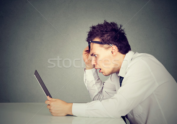 Side profile shocked man looking at laptop computer Stock photo © ichiosea
