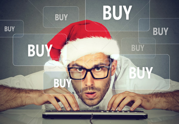 Christmas man in santa claus hat buying stuff online Stock photo © ichiosea