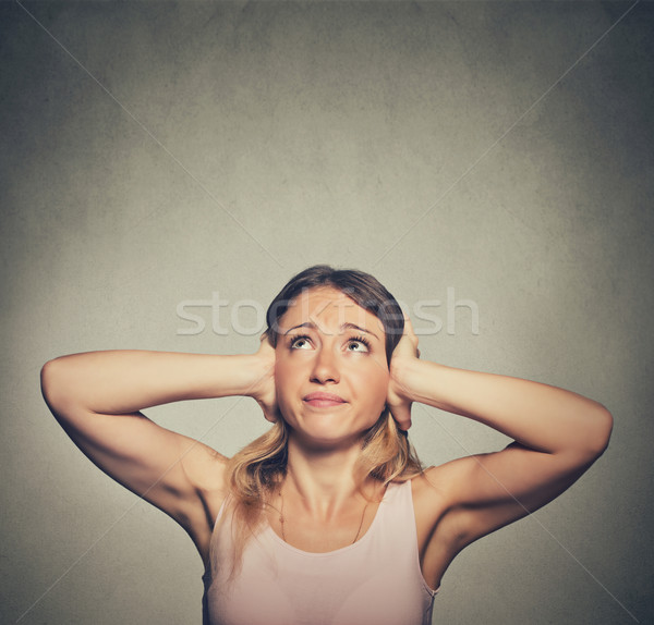 unhappy woman covering her ears looking up stop making loud noise Stock photo © ichiosea