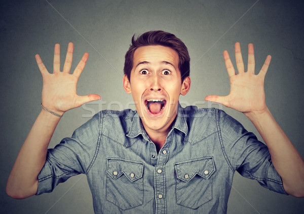 Happy young man going crazy screaming super excited surprised Stock photo © ichiosea