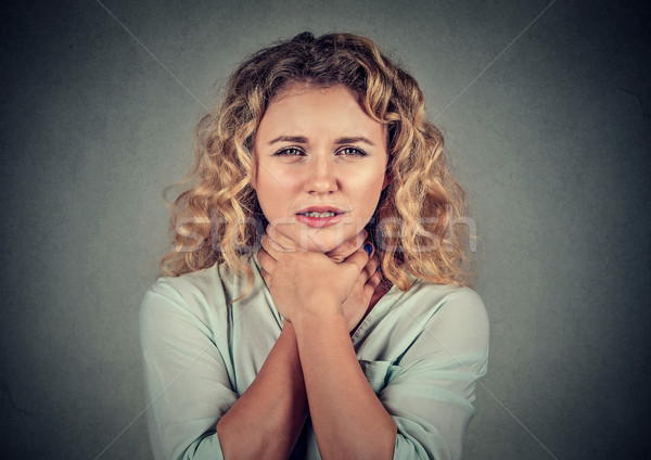 Stock photo: Young woman having asthma attack or choking can't breath