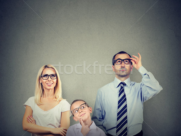 Thoughtful young family mother father and their child looking up contemplating  Stock photo © ichiosea