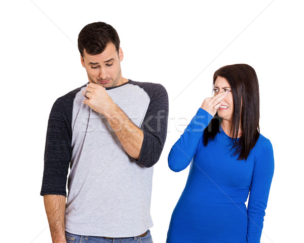 Stock photo: woman covering nose because the man stinks