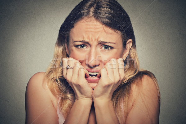 nervous stressed young woman biting fingernails looking anxiously craving Stock photo © ichiosea