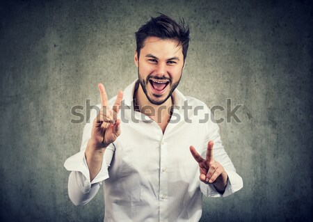 Hopeful handsome man crossing his fingers, eyes closed  Stock photo © ichiosea