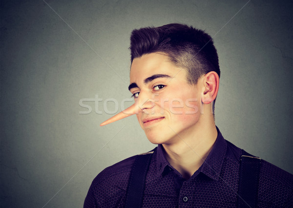 Liar funny looking young sly man  Stock photo © ichiosea