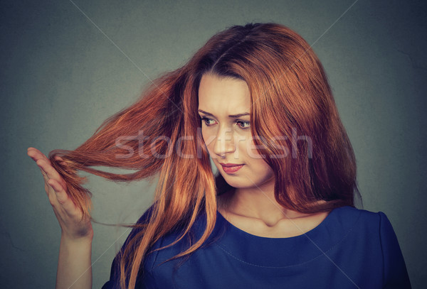 upset frustrated young woman surprised she is losing hair, noticed split ends  Stock photo © ichiosea