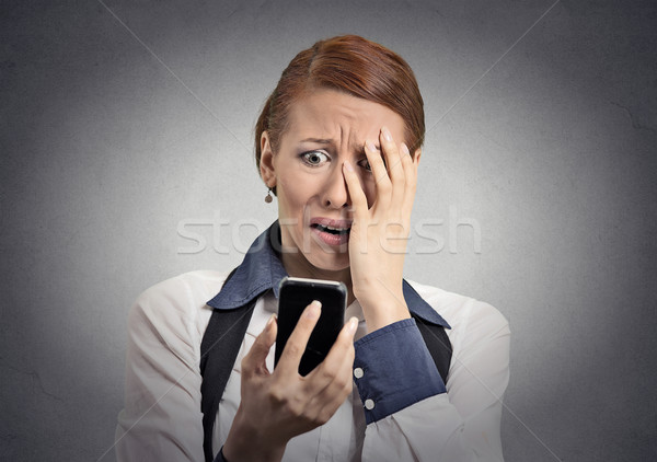 stressed woman shocked with message on smartphone  Stock photo © ichiosea