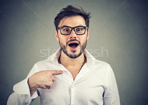 Excited surprised young man pointing at himself in disbelief Stock photo © ichiosea