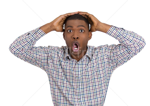 Stock photo: young man with hand on head who is scared, astonished 