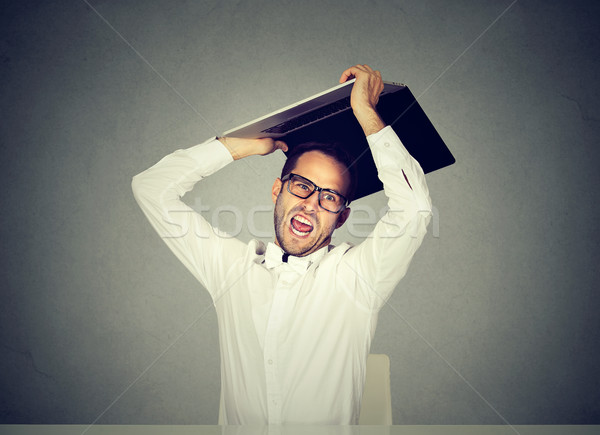 furious nervous business man about to smash throw his laptop computer Stock photo © ichiosea