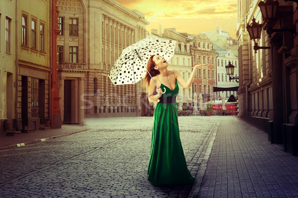 Beautiful young woman with umbrella in an old street town  Stock photo © ichiosea