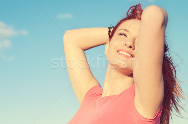 woman smiling looking up to blue sky celebrating enjoying freedom Stock photo © ichiosea