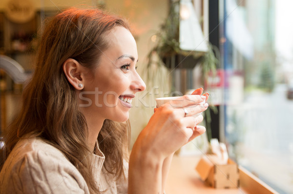 Happy woman drinking coffee in cafeteria Stock photo © ichiosea