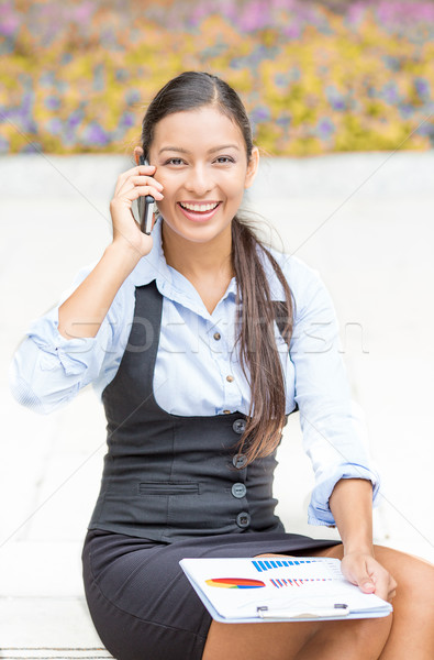 businesswoman sitting outside reviewing financial statements paperwork talking on mobile phone Stock photo © ichiosea