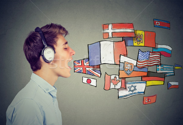 Young man in headphones learning different languages Stock photo © ichiosea