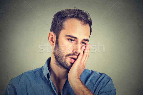 portrait of desperate unhappy man isolated on gray wall background  Stock photo © ichiosea