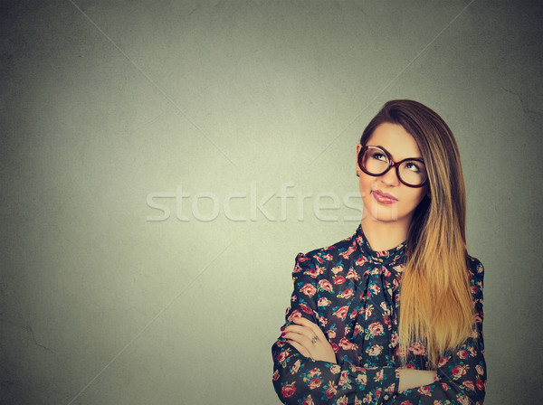 unny confused young skeptical woman in glasses thinking looking up  Stock photo © ichiosea
