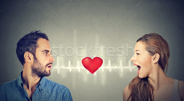 Love connection. Man woman talking to each other with heart in-between   Stock photo © ichiosea