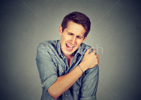 man suffering from neck or shoulder pain  Stock photo © ichiosea