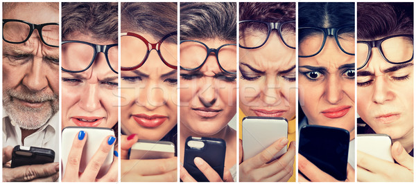 Group of people men and women with glasses having trouble seeing cell phone Stock photo © ichiosea