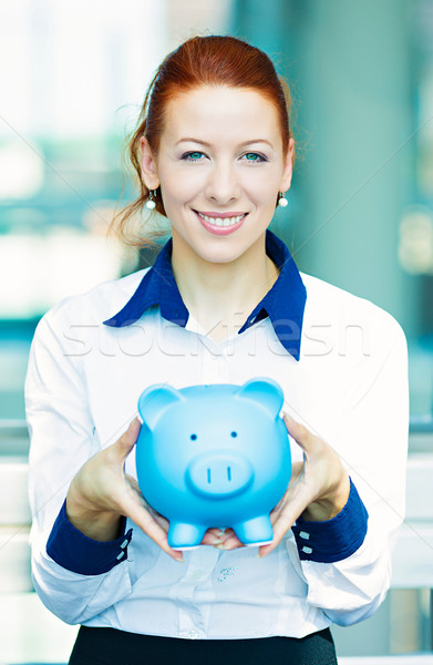 Stock photo: Business woman holding piggy bank