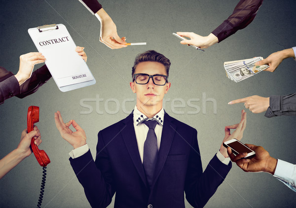 Young businessman is meditating to relieve stress of busy corporate life  Stock photo © ichiosea
