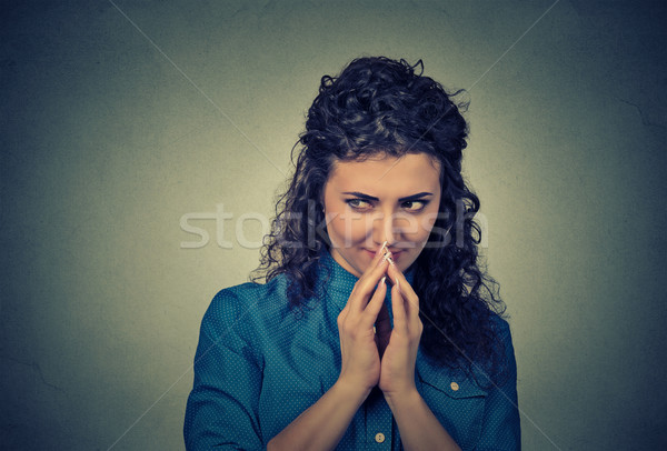 Stock photo: sneaky, sly, scheming young woman plotting something