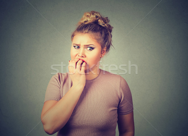 nervous stressed young woman student biting fingernails looking anxiously craving Stock photo © ichiosea
