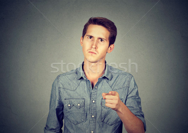 angry young man pointing finger at you camera  Stock photo © ichiosea