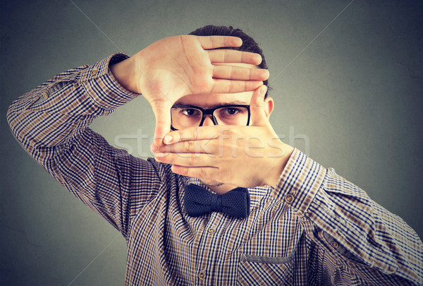 Serious young man making a frame with his hands looking at camera Stock photo © ichiosea