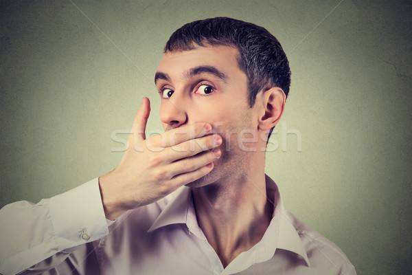 Headshot of a scared adult man with hand covering his mouth  Stock photo © ichiosea