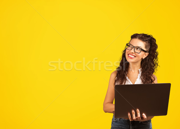 positive cool lady with curly hair holding laptop looding away daydreaming Stock photo © ichiosea